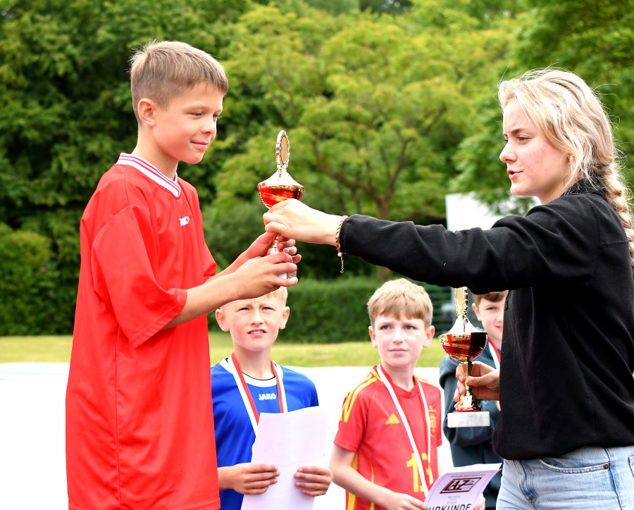 Hier erh&auml;lt der Drittplatzierte der Altersklasse 2015, Levin Schmidt von der Wieseschule, den Pokal von LAZ-Trainerin Maya Klute &uuml;berreicht. Foto: Bottin